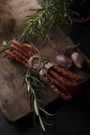 Smoked sausage, a composition of traditional dry, thin rural meats on background. Regional food.の写真素材