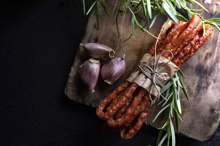 Smoked sausage, a composition of traditional dry, thin rural meats on background. Regional food.の写真素材