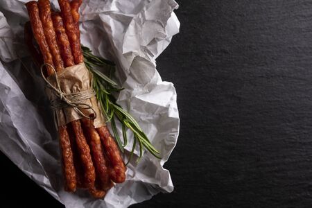 Smoked sausage, a composition of traditional dry, thin rural meats on background. Regional food.の写真素材