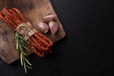 Smoked sausage, a composition of traditional dry, thin rural meats on background. Regional food.の写真素材