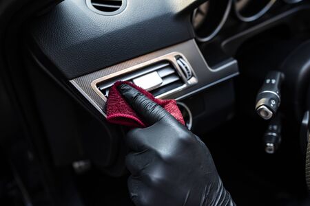 Man polishes a car interior with a clothの写真素材