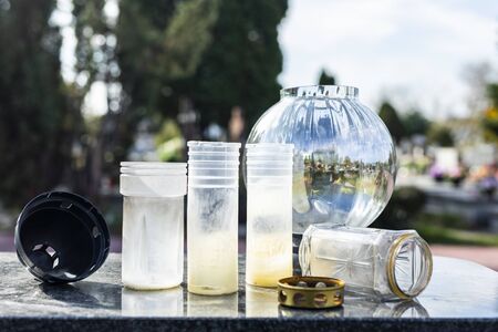 Burnt-out grave candles after All Saints Day. Empty grave lanterns on a tombstone, on a cemetery.の写真素材