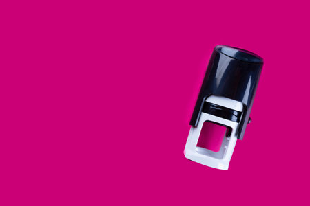 Stamps and date stamps, office accessories on a pink background