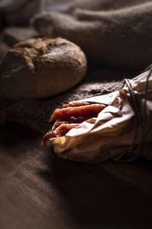 Smoked sausage, a composition of traditional dry, thin rural meats on background. Regional food.の写真素材