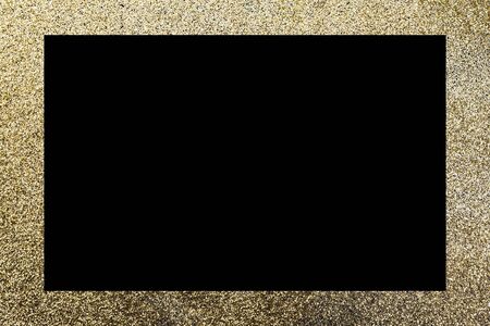 Golden glitter, rectangular frame on a deep black surface. Shining luxury background for Christmas, new year, birthday, special occasions, promotions, with a copy space.の写真素材