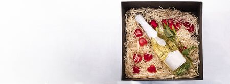 Gift box - red roses, hearts, champagne isolated on white. Valentines Day.の写真素材