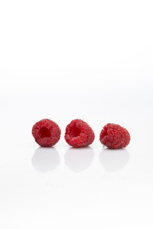Three ripe, raspberry fruits isolated on a white background. Packshot photo. Design element, www,...