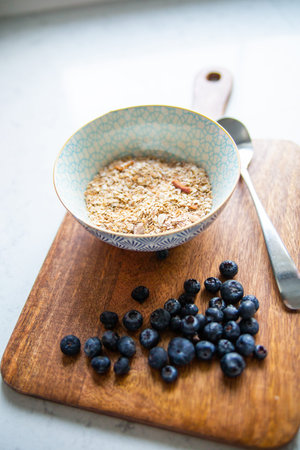 A dietetic, healthy breakfast concept. A bright composition of granola, muesli, oatmeal in an...