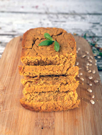 Plant based, meat free products. Vegan, vegetable pate, sliced on wooden board. Rustic composition on vintage boards.の写真素材