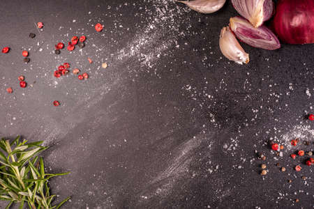 Fresh herbs, spices, garlic and red onion on blackboard, top view. Horizontal banner with a copy-space, text space.の写真素材