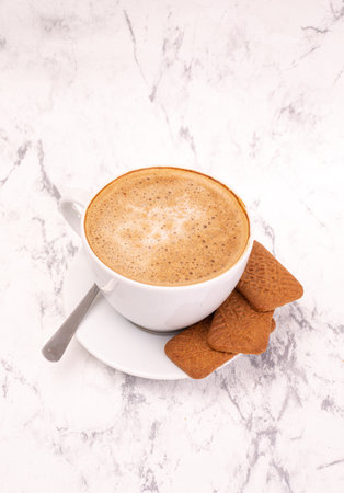 Cup of coffee on a marble background. Perfect cappuccino, hot chocolate, latte coffee and cookies, top view.の写真素材