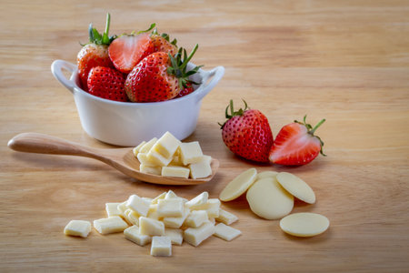 Raw white chocolate and Strawberry on wood background