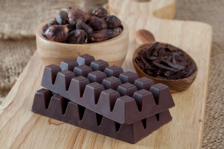 Raw cocoa beans, chocolate on wood backgroundの写真素材