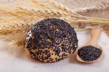 a fresh baked loaf of whole grains bread with poppyの写真素材