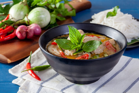 Green curry with fish ball on wooden background ,Thai cuisine