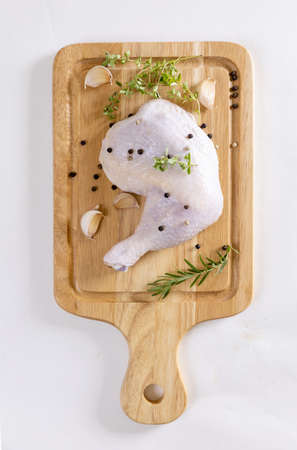 Raw chicken legs on cutting boardの写真素材