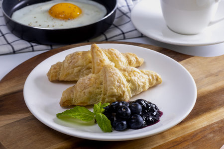 Home made croissant breakfast with fried eggsの写真素材