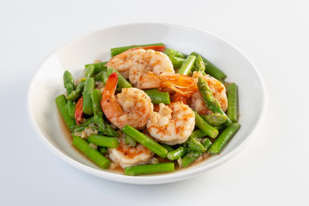 Asparagus stir fried with shrimp isolated white backgroundの写真素材
