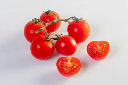 Freshly prepared ketchup with ripe red tomatoes on a white backgroundの写真素材