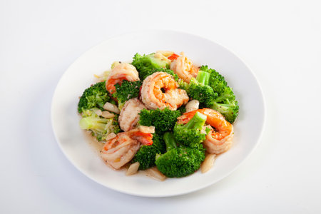 Stir fried broccoli and shrimp on a white backgroundの写真素材