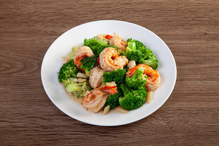 Stir fried broccoli and shrimp on the wooden floorの写真素材