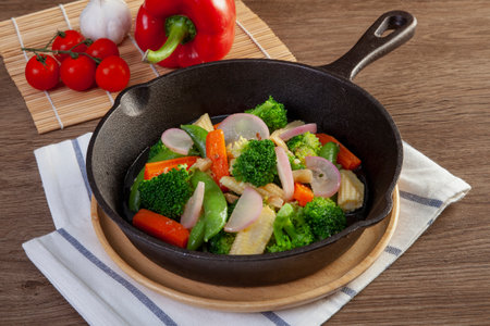 Stir fried mixed vegetables in a pan on the table.の写真素材