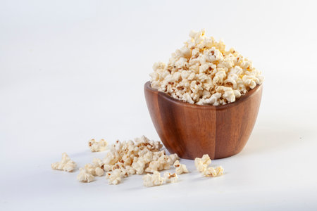 Popcorn in brown bowl on white backgroundの写真素材