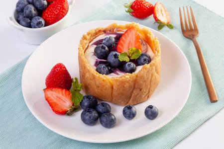 Homemade cheesecake with fresh Strawberry and blueberries on the tableの写真素材