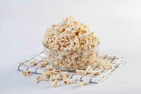 Popcorn in brown bowl on white backgroundの写真素材