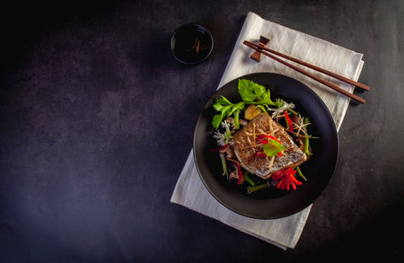 Steamed Grouper with Soy Sauceon a black backgroundの写真素材