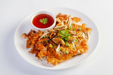 Crispy fried mussels omelette served with bean sprout and spicy sauce.の写真素材