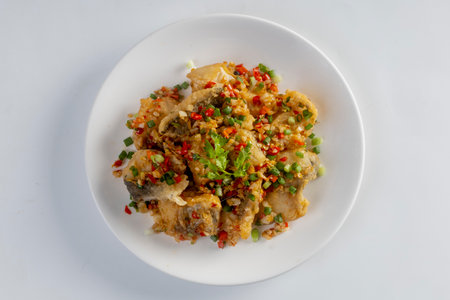 Fried snapper with chili and salt isolated on white backgroundの写真素材