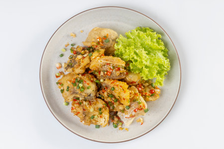 Fried snapper with chili and salt isolated on white backgroundの写真素材