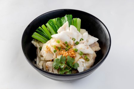 egg noodle in bowl with slice red roasted pork, pork's wontons and white crab meat on it.
