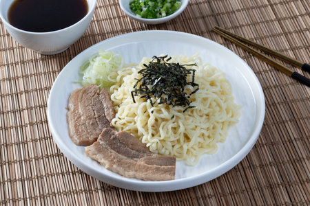 Cold ramen with pork belly on a white plate on the table.の写真素材