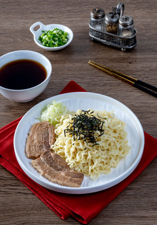 Cold ramen with pork belly on a white plate on the table.の写真素材