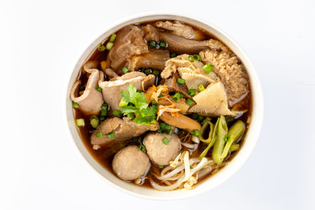 Stewed Beef and Offal Noodle Soup, Thai Stew Food and Vegetables in Bowl on White Background