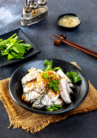 steamed sea bass sliced fish with dipping sauce and vegetableの写真素材