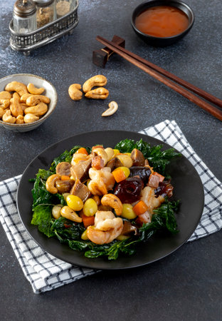 Stir fried mixed Chinese fruits and nuts  on a black plateの写真素材