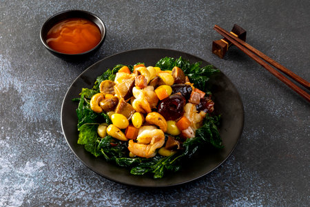Stir fried mixed Chinese fruits and nuts  on a black plateの写真素材