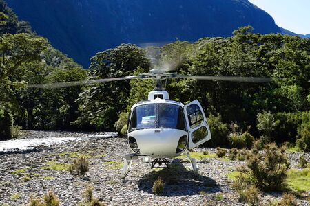 Running helicopter landed on gravel in Campbell's Kingdom - Fjordland National Park - Doubtful Soundの写真素材