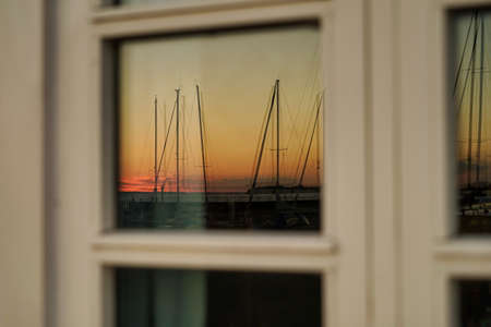 sunset in marina, reflected in windowの写真素材