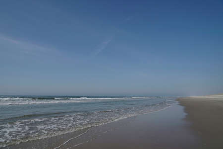 wet sand and waves on beach, Jutland, Denmarkの写真素材