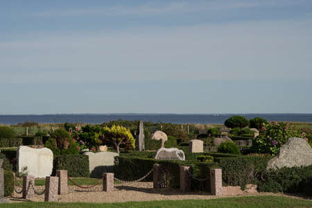 Haurvig Kirke cemetery with sea in background and blue skyの写真素材