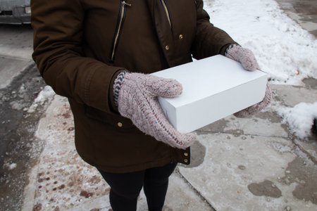 Woman holding a box of donuts in London, Ontario, Canada
