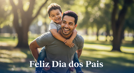 A joyful father carries his son on his shoulders, celebrating Father's Day outdoors with a smile.の素材