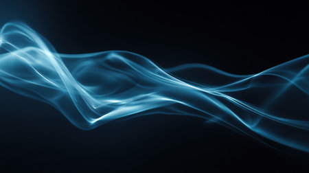 Abstract image featuring flowing, translucent blue smoke trails against a dark background, creating a sense of mystery and movement.の素材