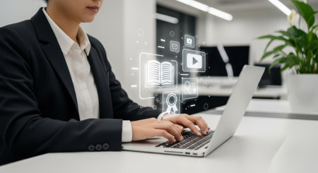 A woman in a suit types on a laptop, surrounded by digital icons, in a modern office setting, symbolizing technology and business.の素材