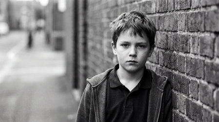 Black and white portrait of a teenage boy in an urban environment.の素材