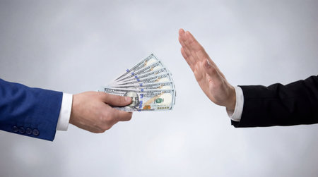 Hands of a businessman and a businesswoman exchanging dollar bills.の素材